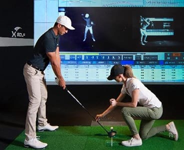 Can I play with friends using an indoor golf simulator?